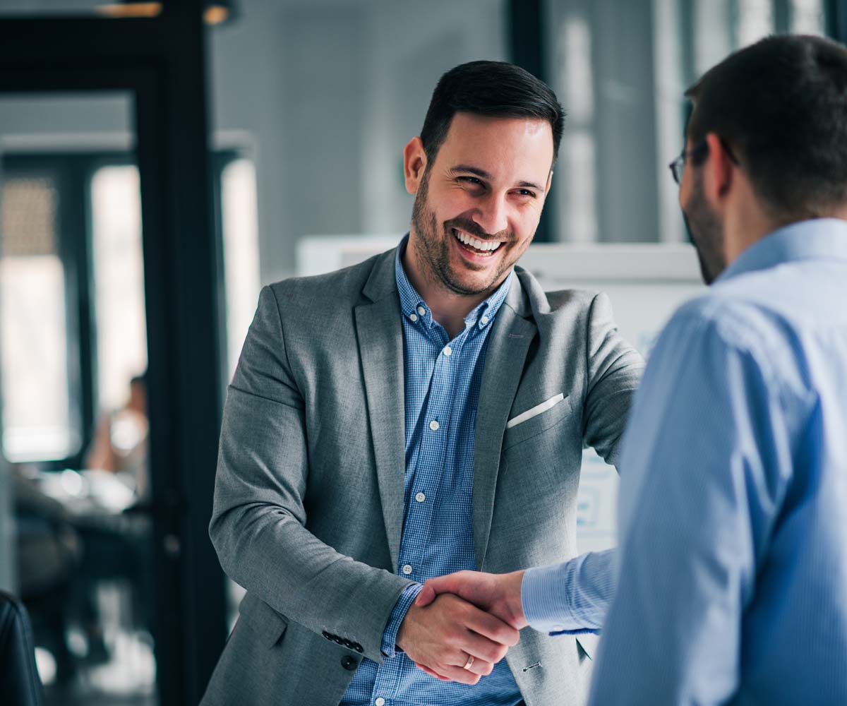 Smiling businessman shaking hands with client